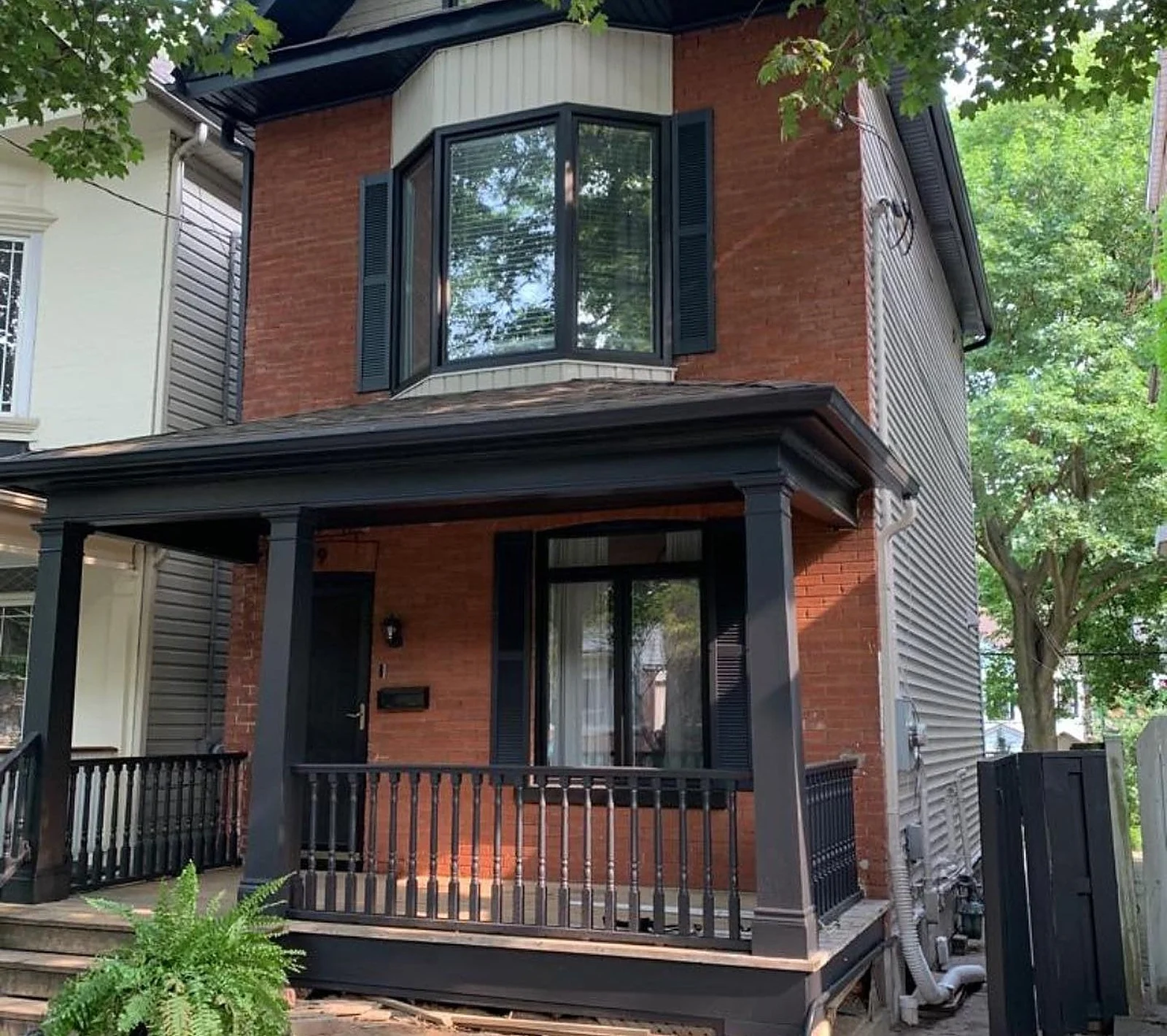 Riverdale semi with porch and trim painted black