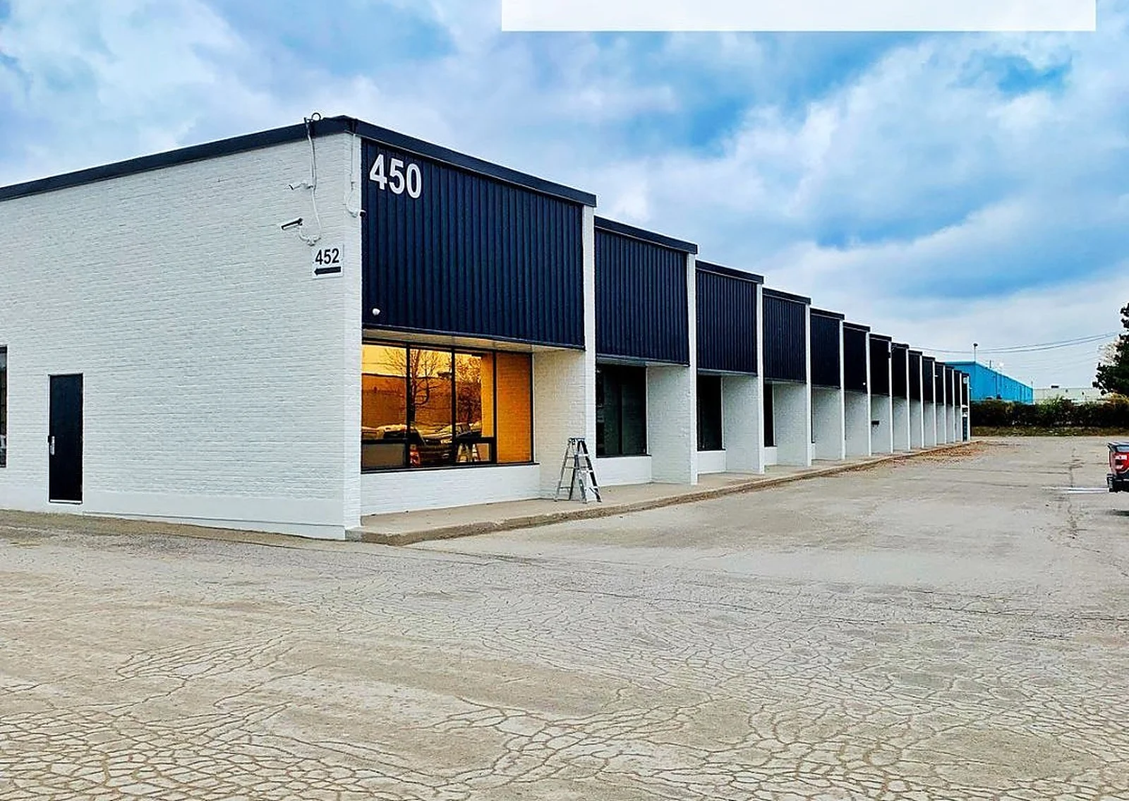 Commercial building painted white with black bands