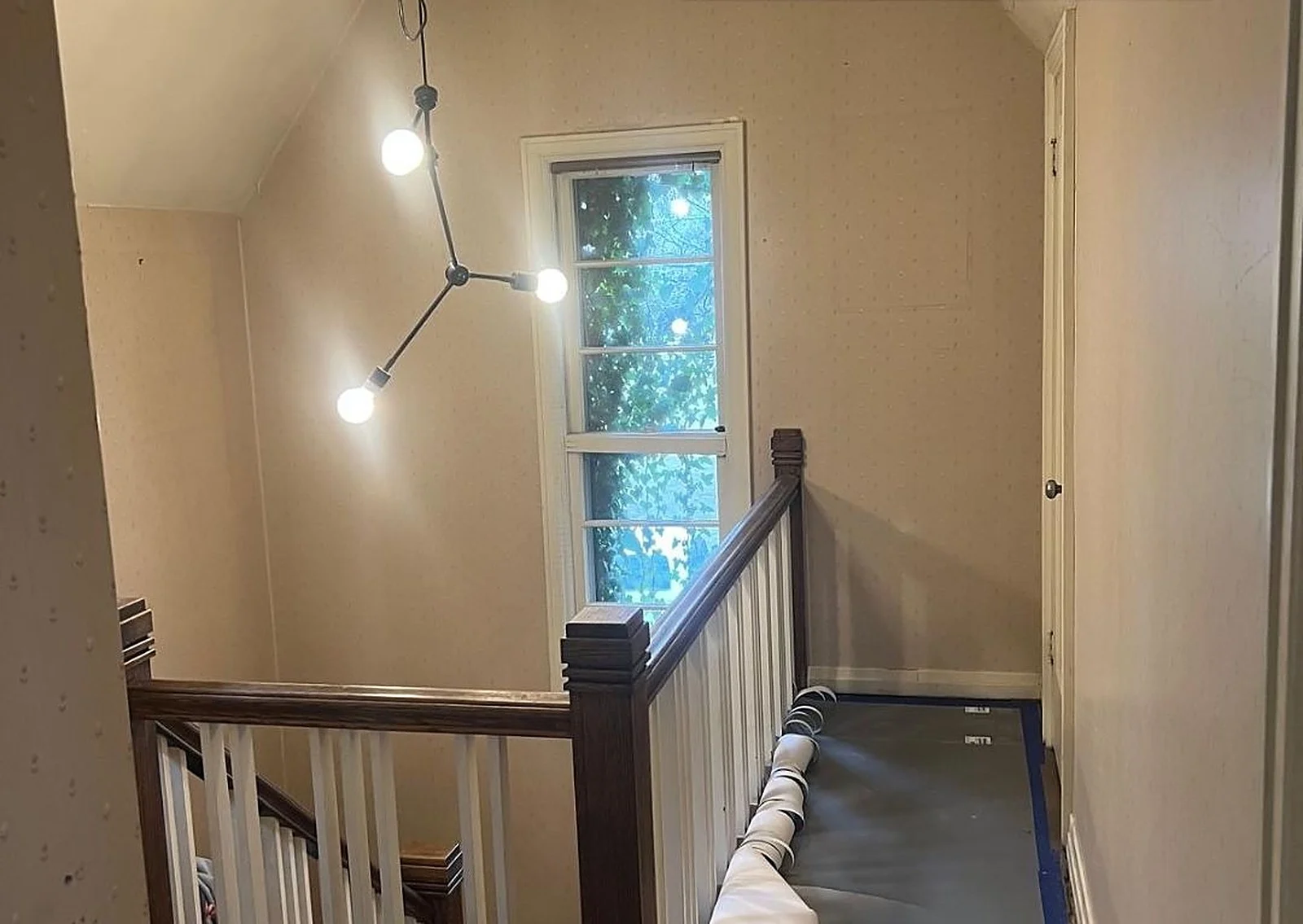 Before: A Hamilton stairwell, wallpaper removed and painted