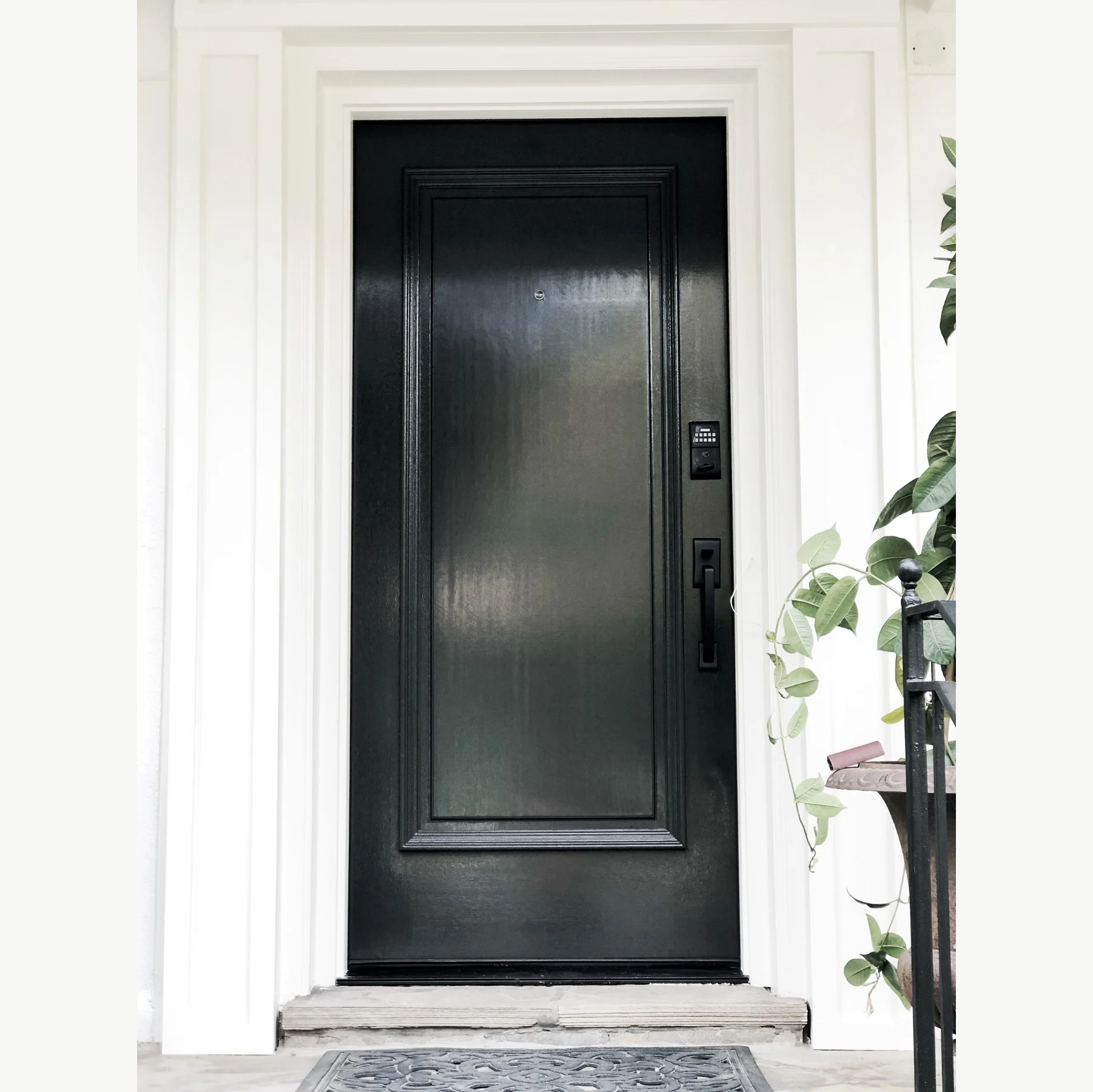 Glossy black front door with fresh white trim