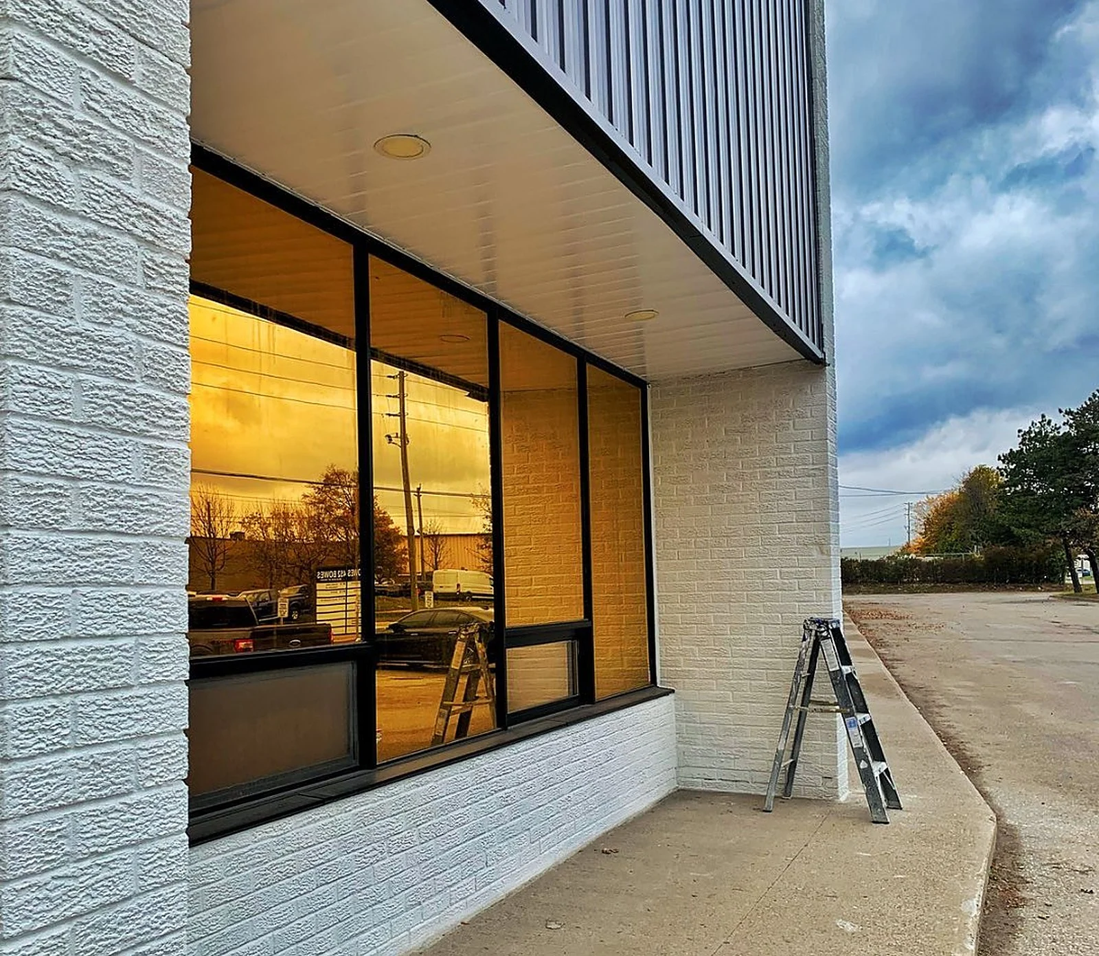Vaughan commercial building, painted white brick and black siding, close up