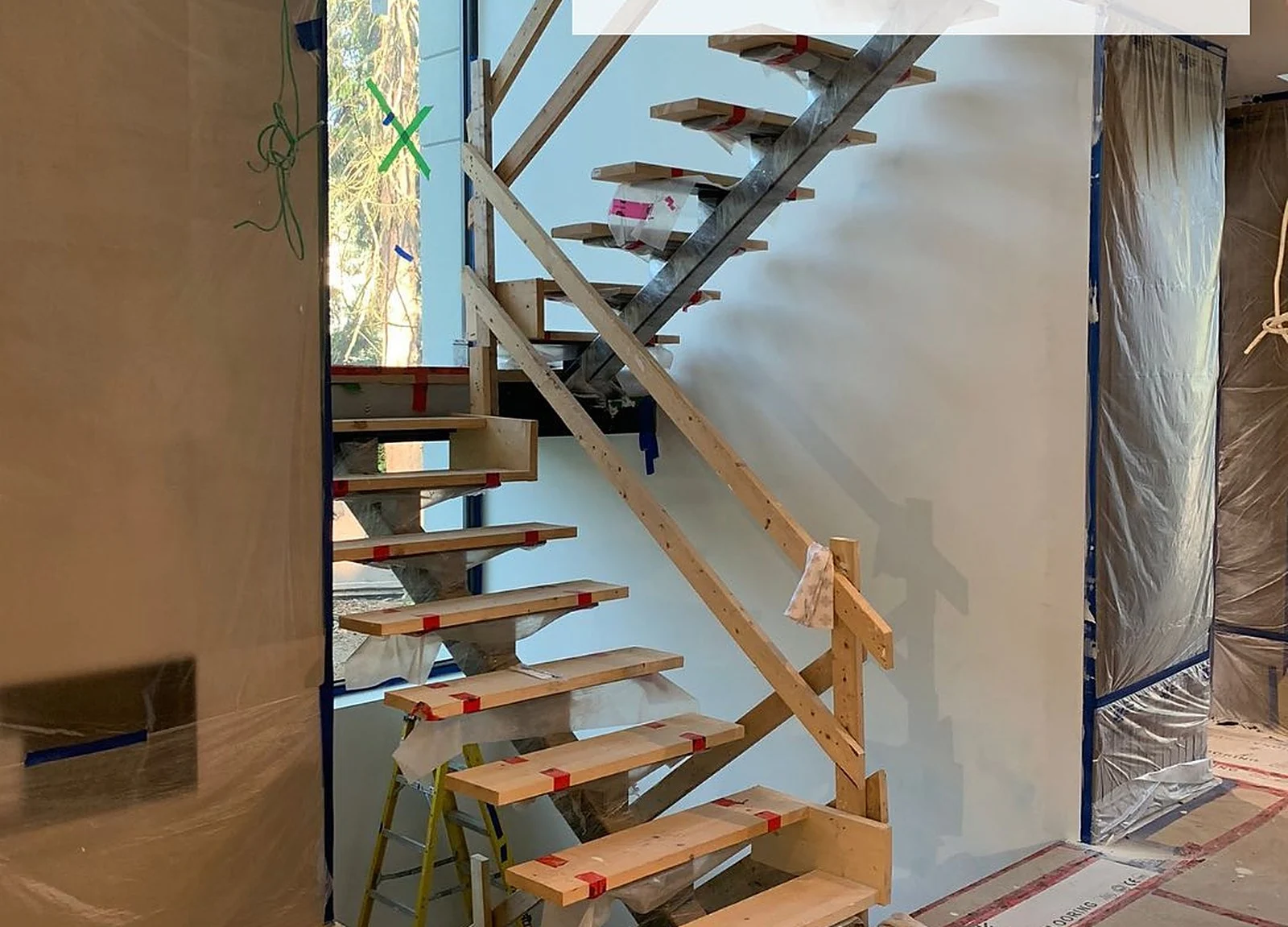 BEFORE: Mississauga custom home floating staircase, raw wood treads (Rymes Fine Homes)