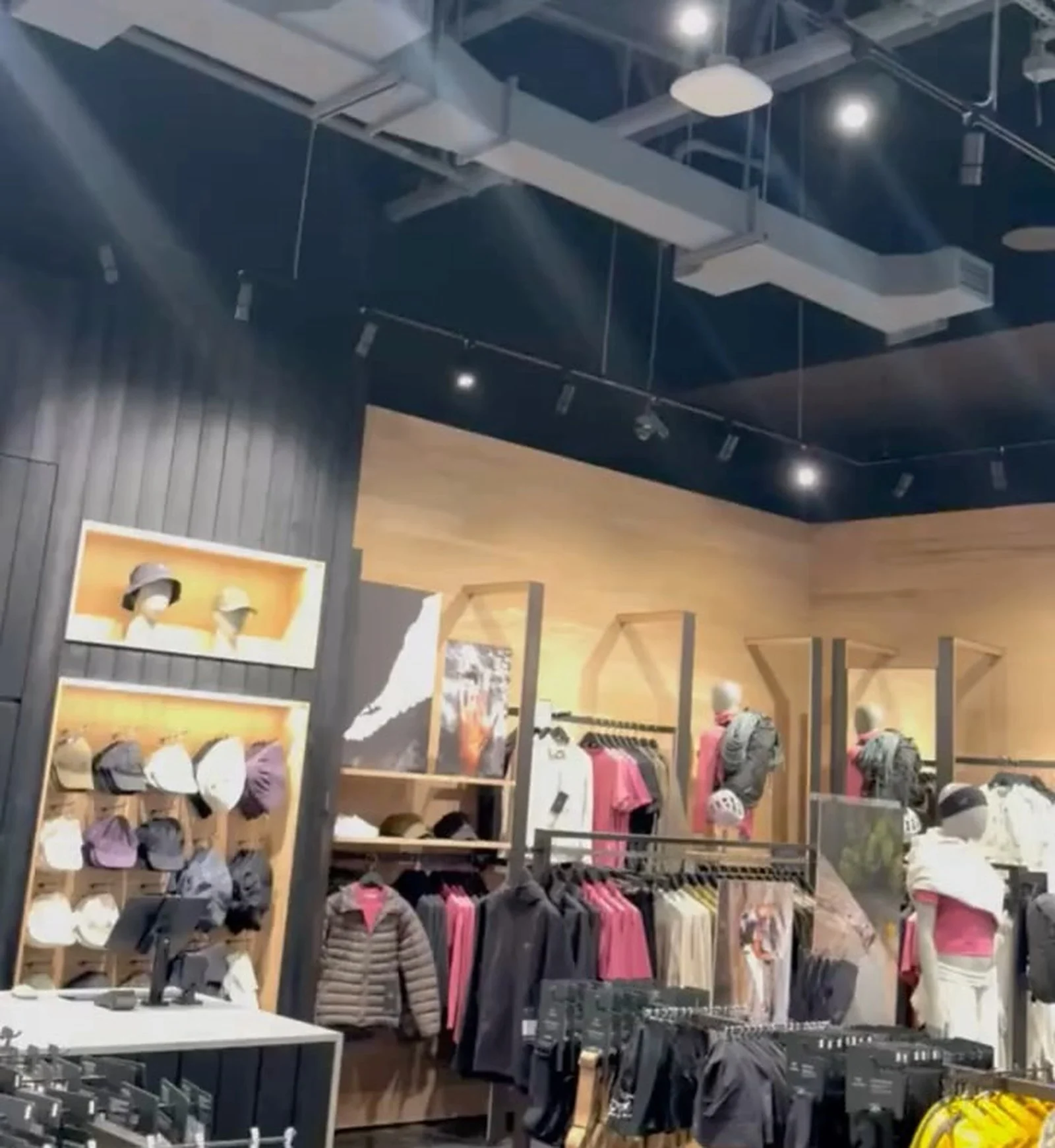 Arc'teryx CF Markville interior, black ribbed walls, wood display bays, apparel