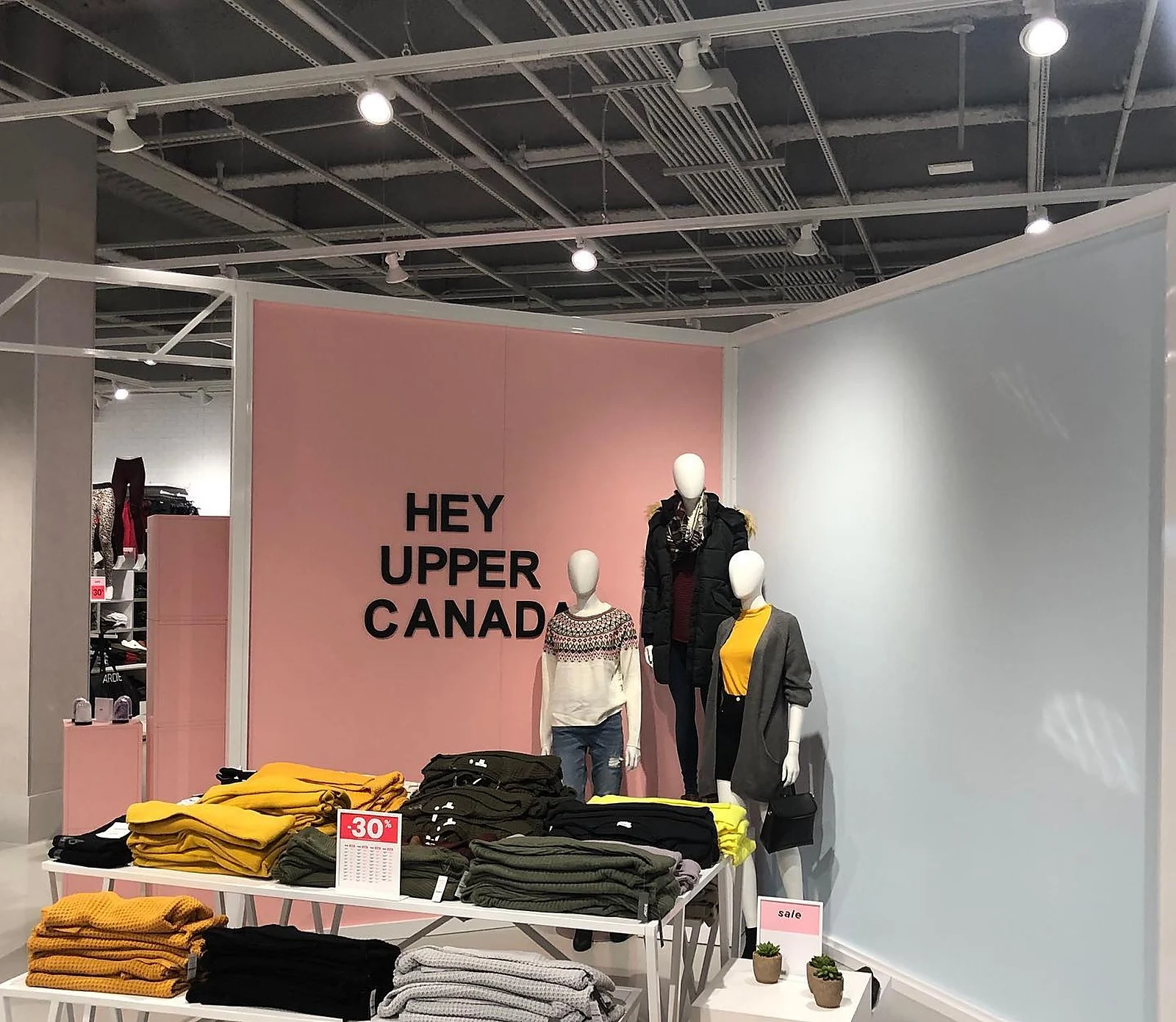 Ardene interior, pink "Hey Upper Canada" feature wall