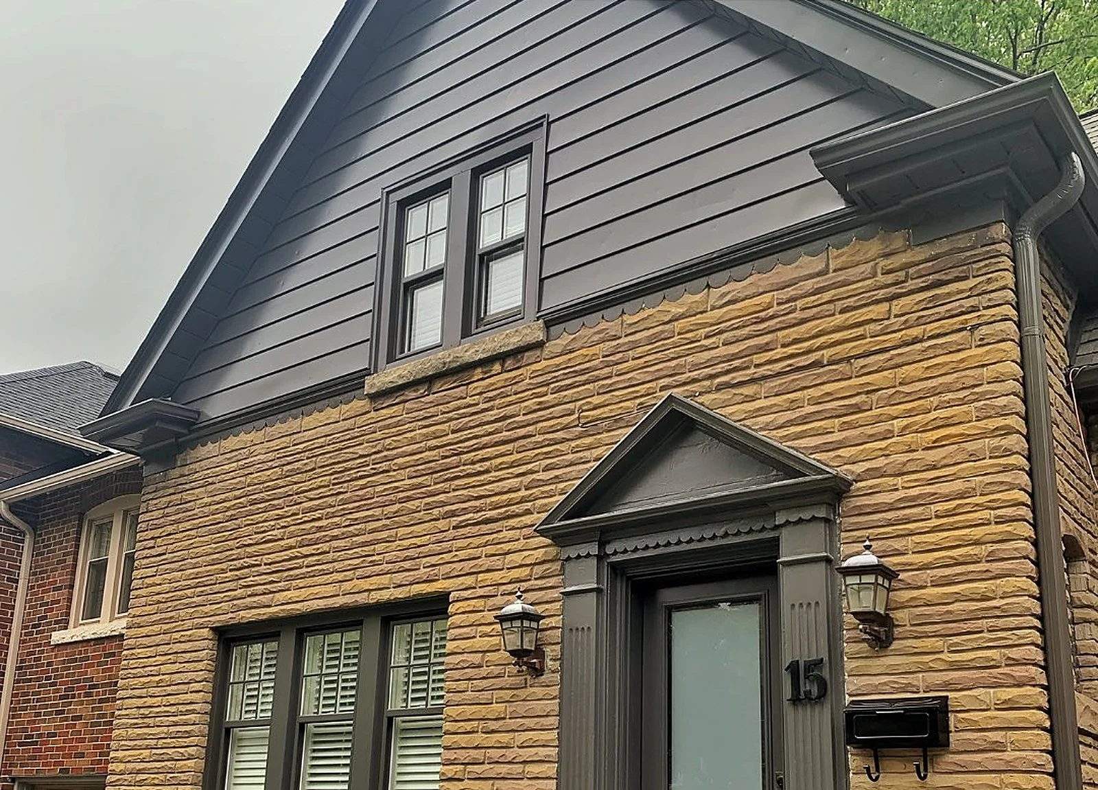 AFTER: same house close-up, charcoal siding