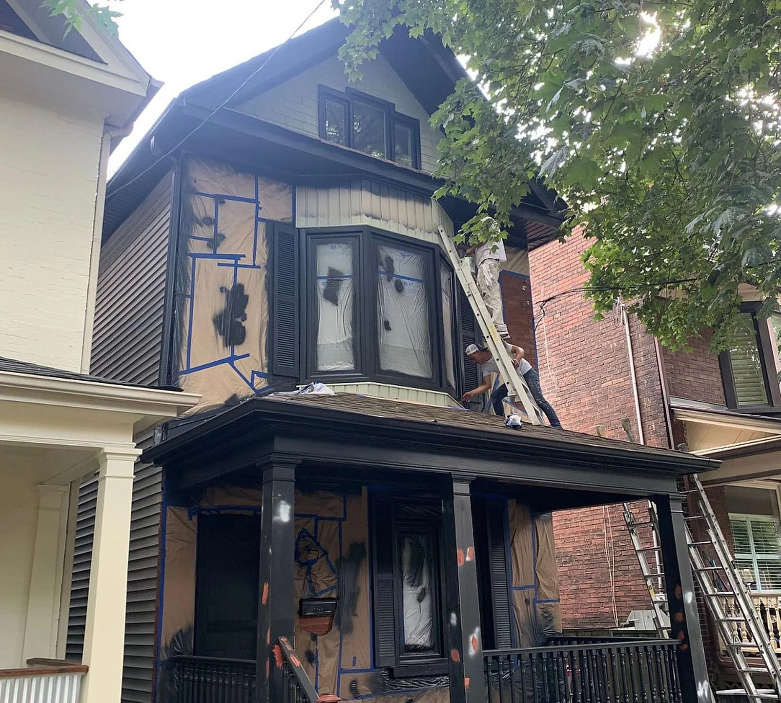 DURING: porch and trim being painted black