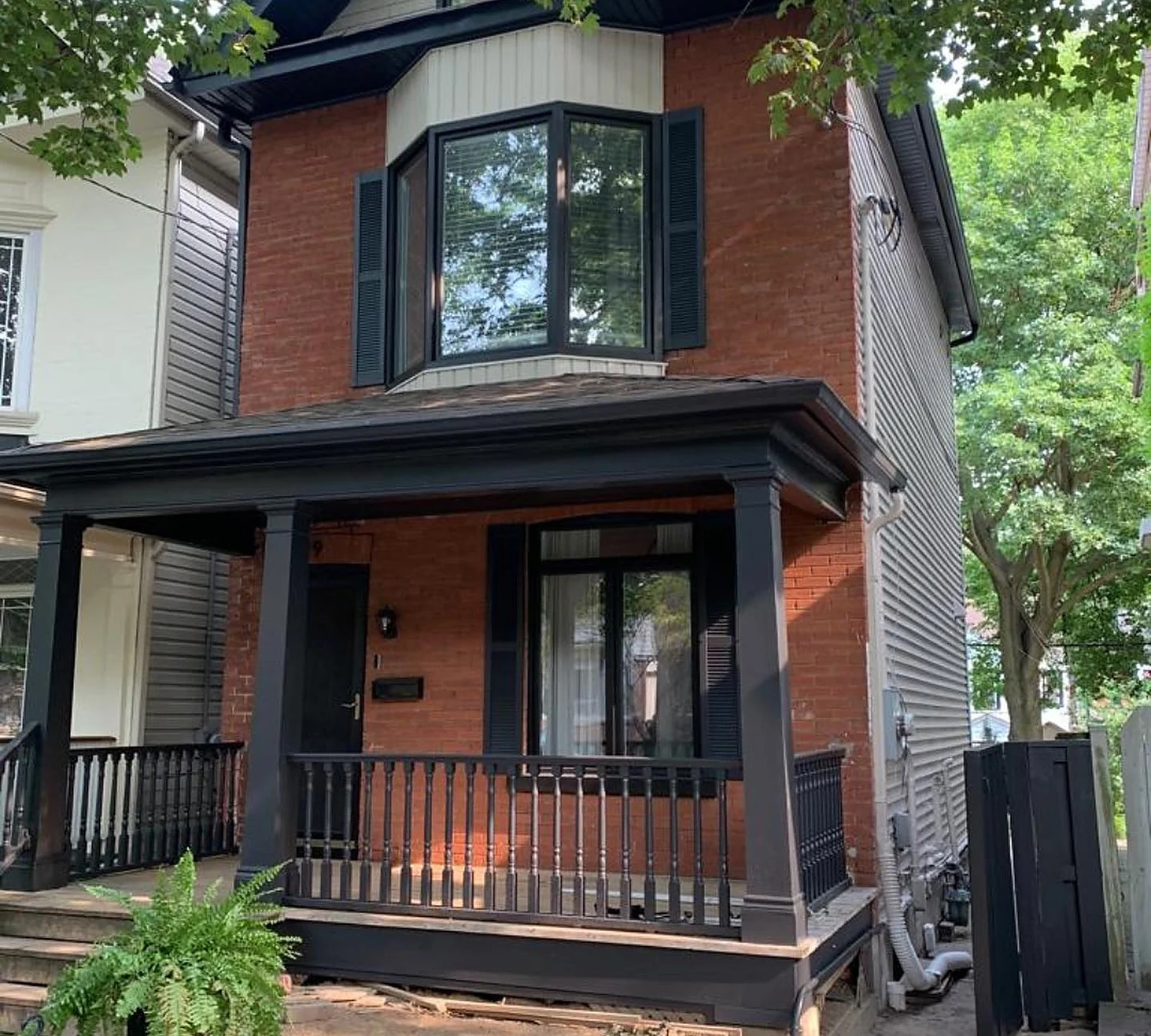 AFTER: Riverdale house with black porch, trim and shutters
