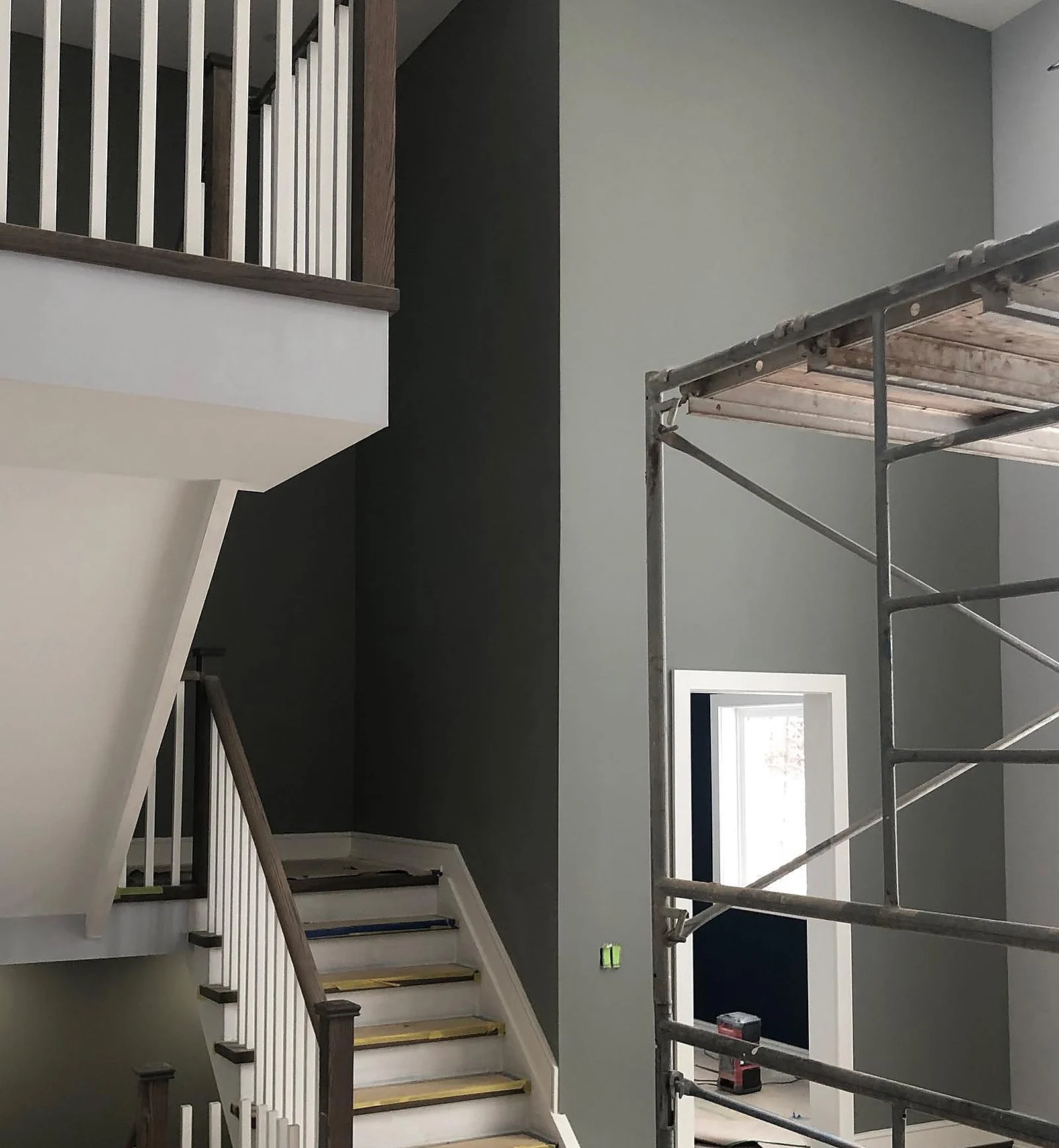 Stairwell dark wall with scaffold, in progress
