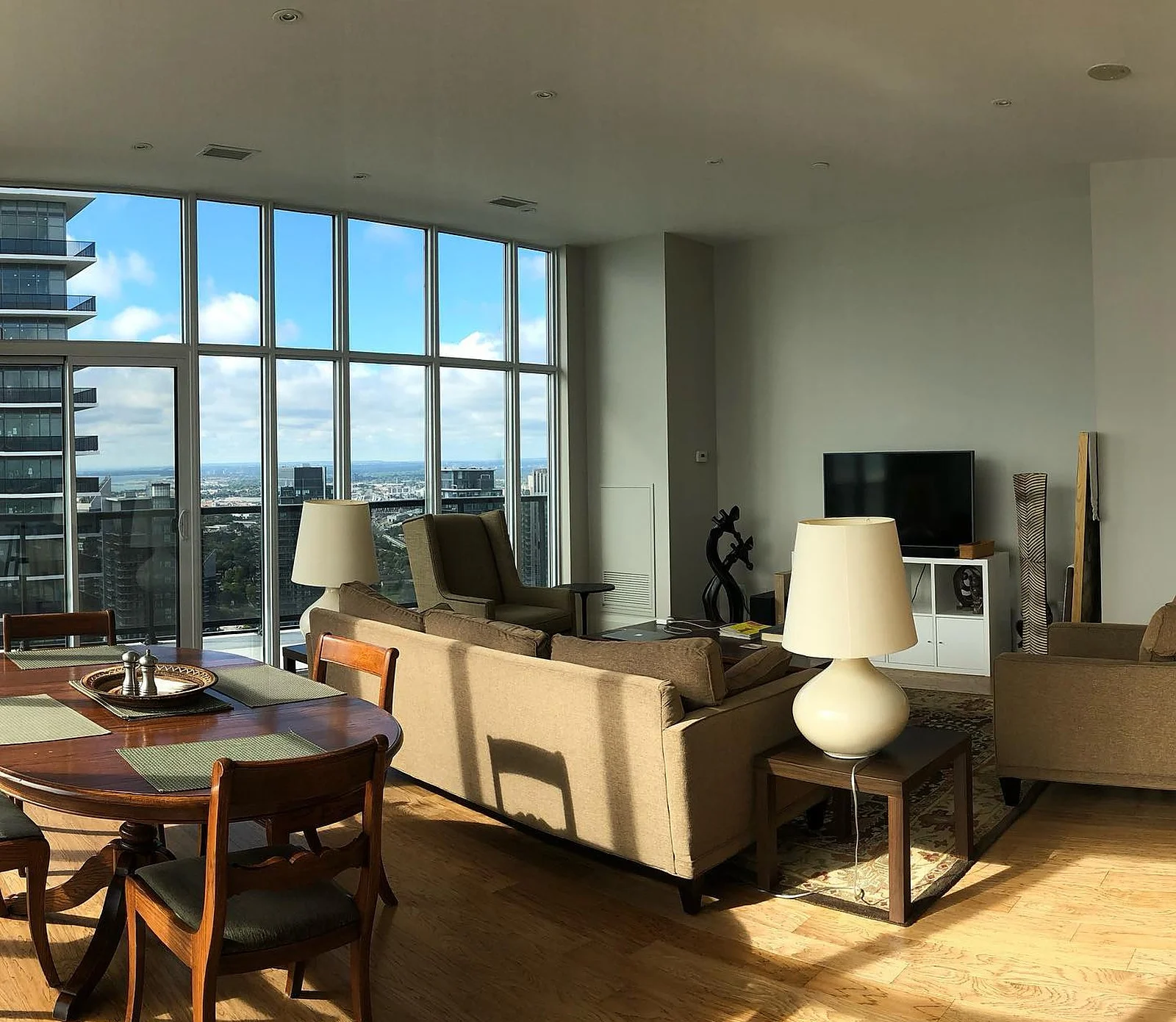 Lakeshore penthouse living/dining with floor-to-ceiling windows