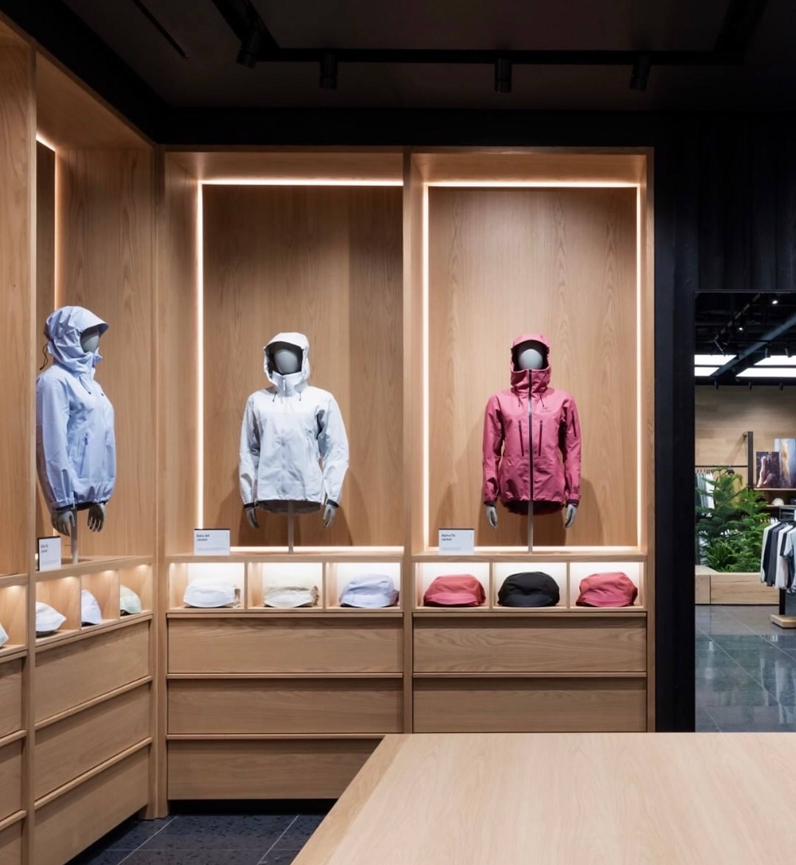 Arc’teryx display wall with lit oak bays at CF Markville