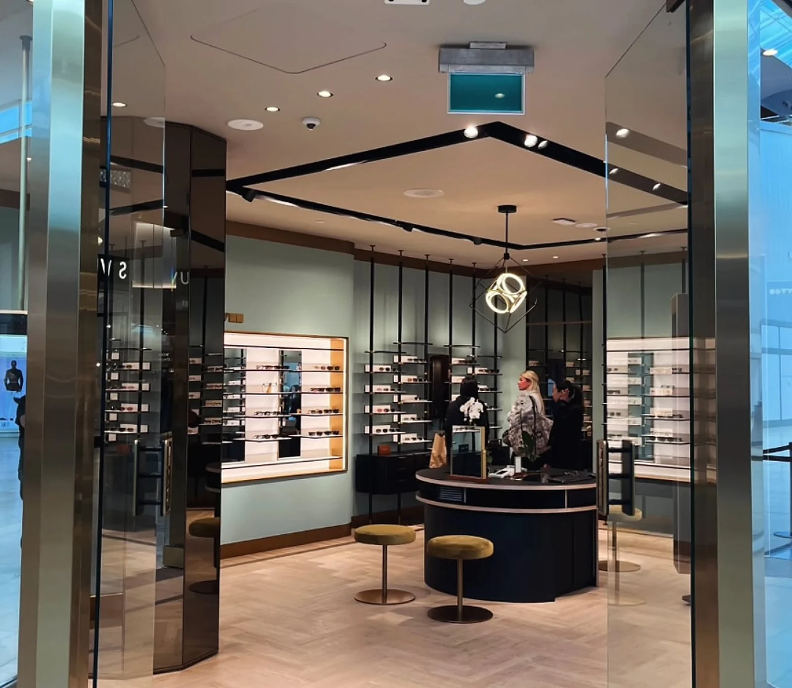 Oliver Peoples interior, mint green walls, black ceiling bands