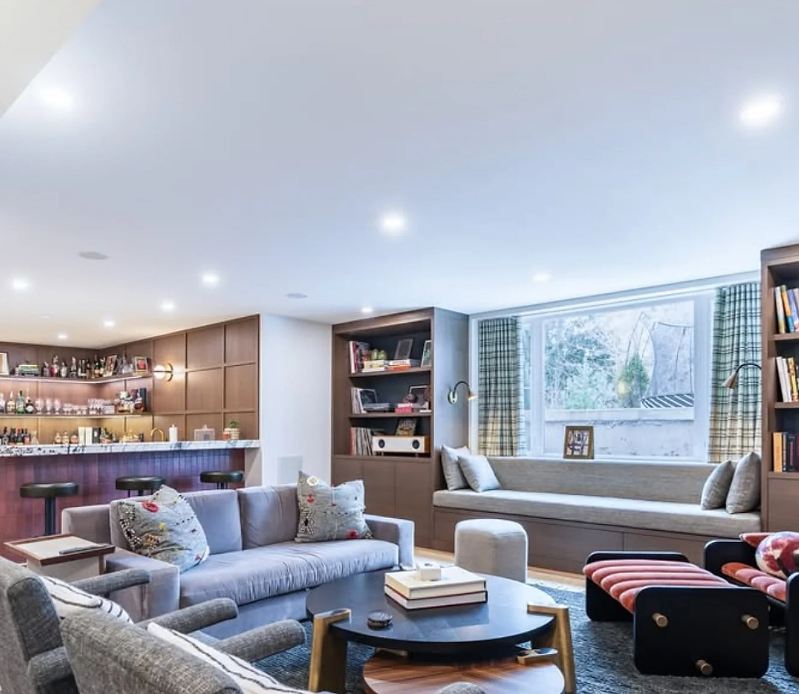 Family room with wood built-in shelves, navy accents