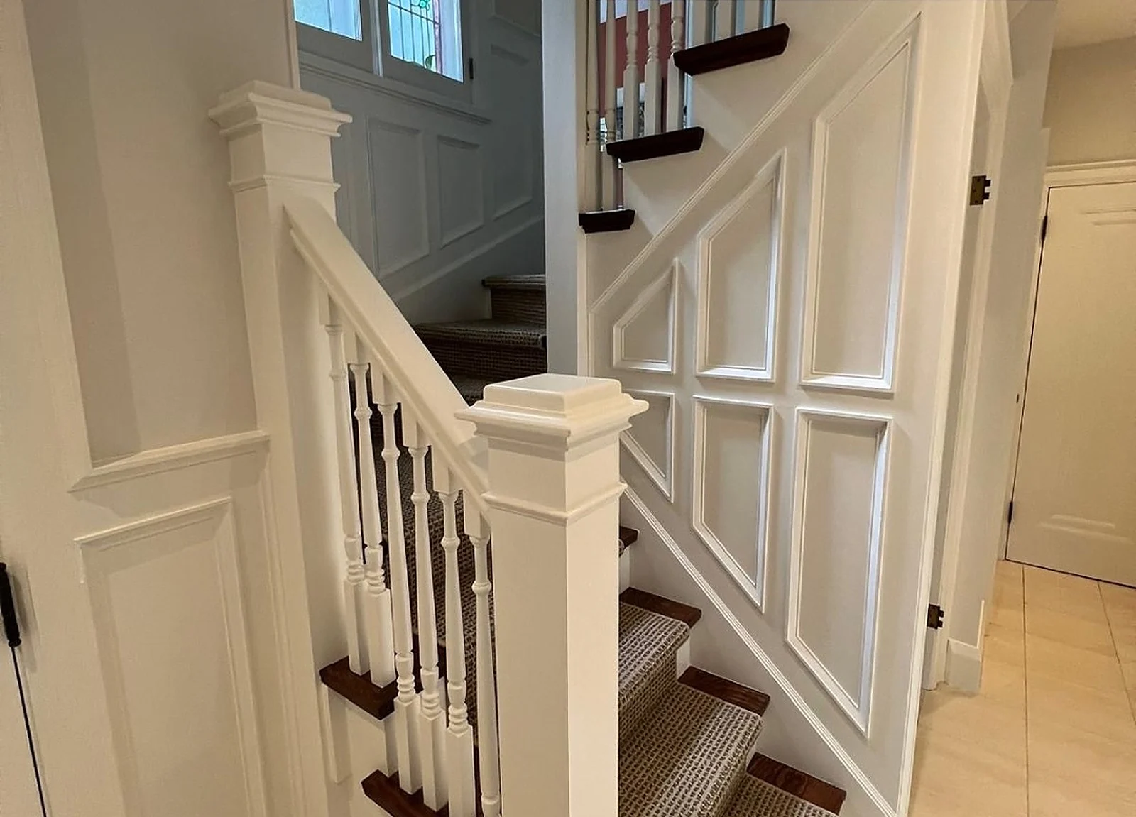 AFTER: same staircase painted white, panelled wall