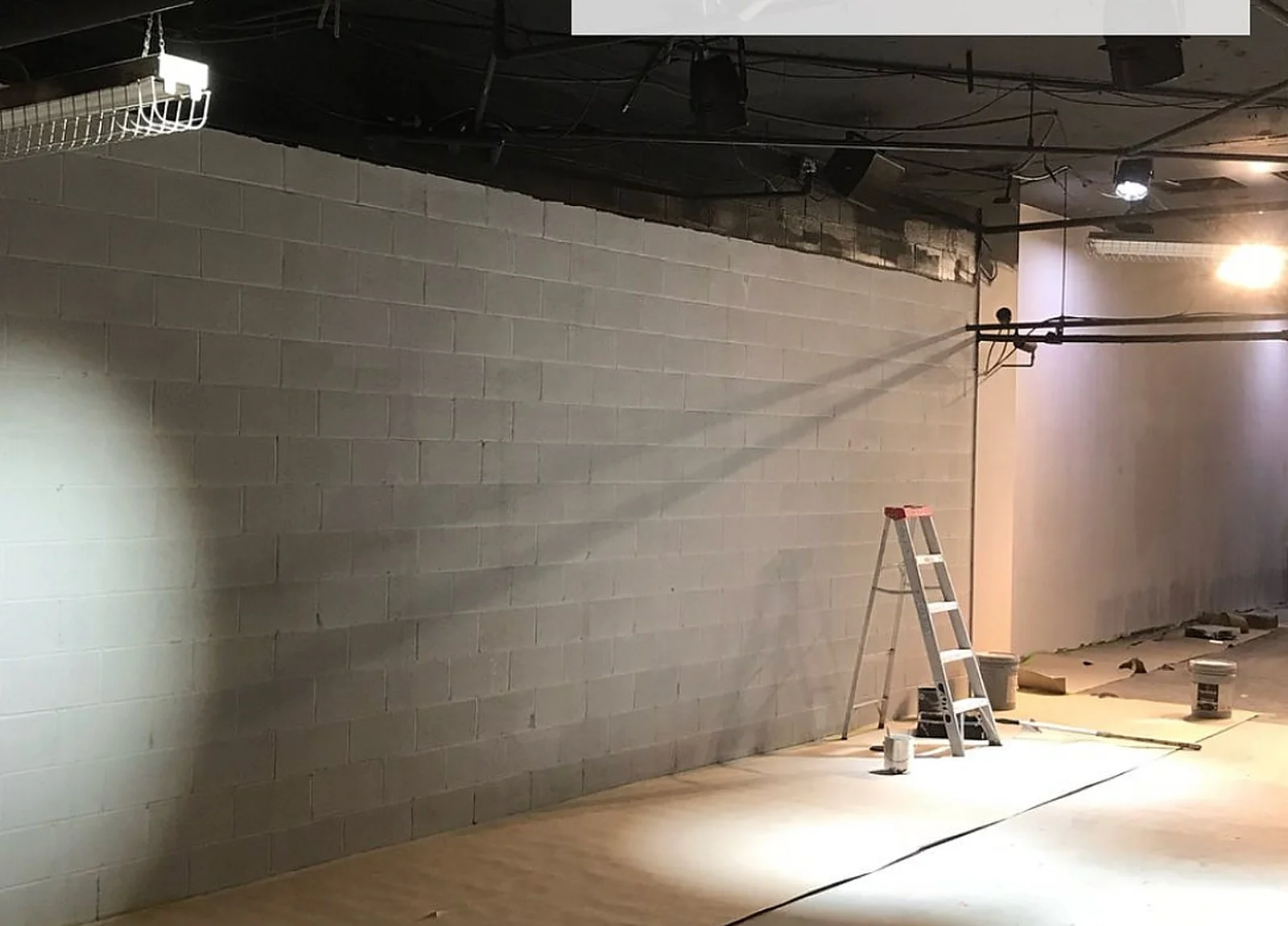 BEFORE: Nike store raw grey block wall