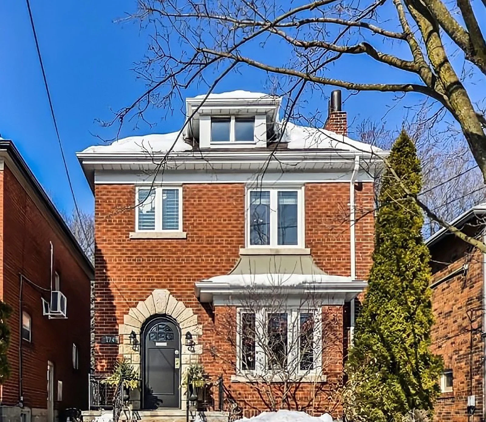 Midtown red-brick house exterior in snow