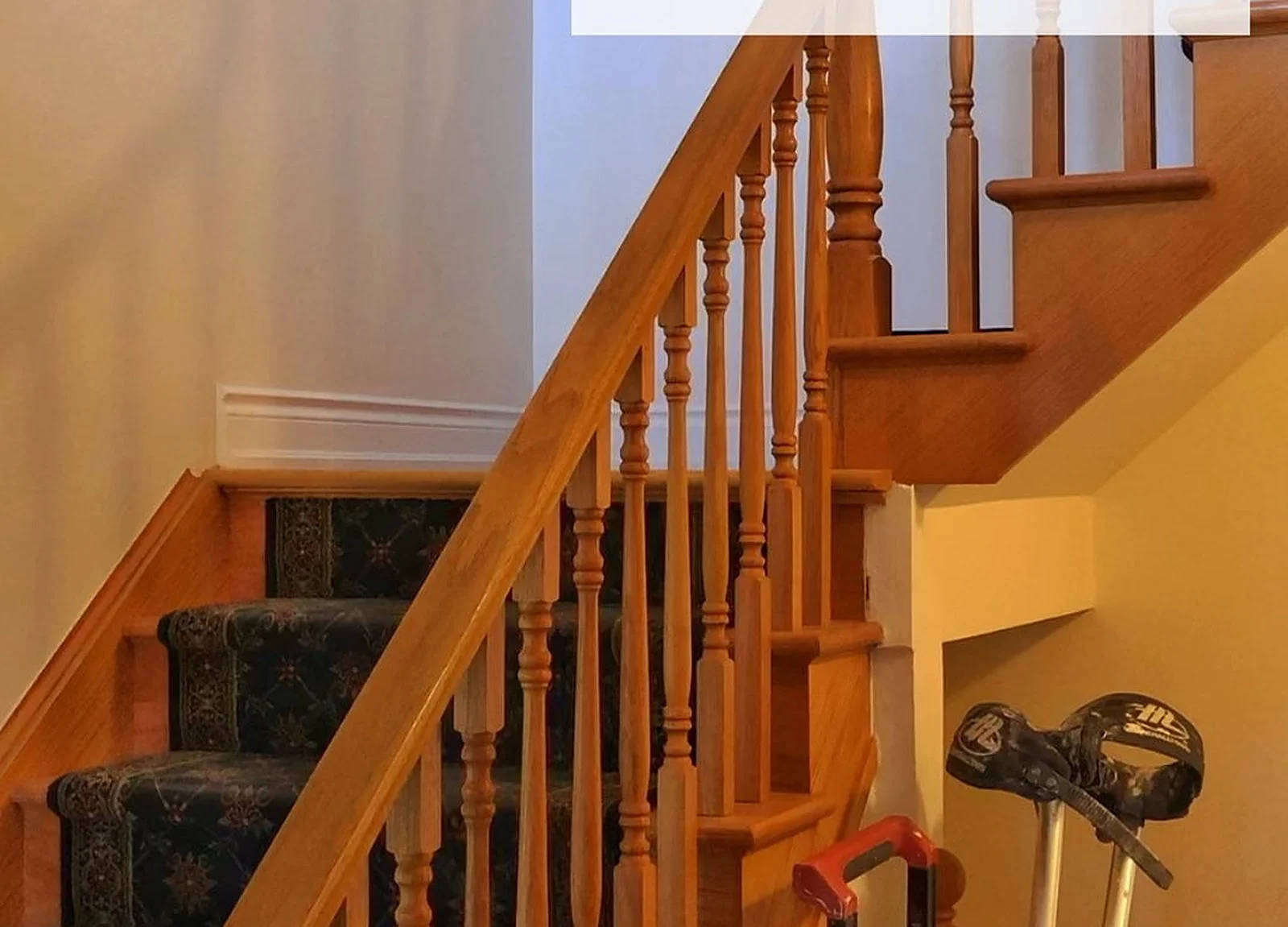 BEFORE: orange oak staircase and railings