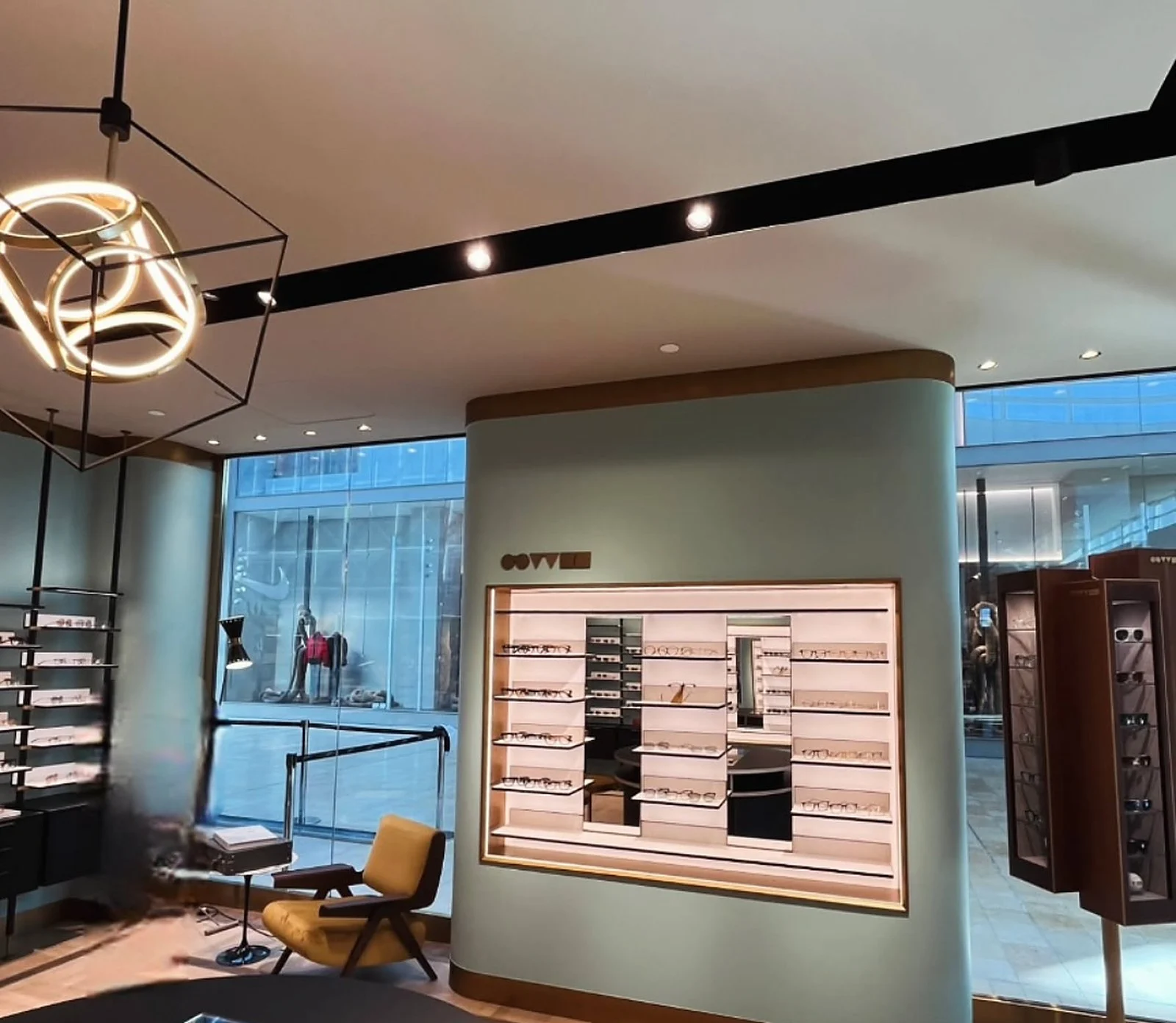 Oliver Peoples display wall, mint green curved wall