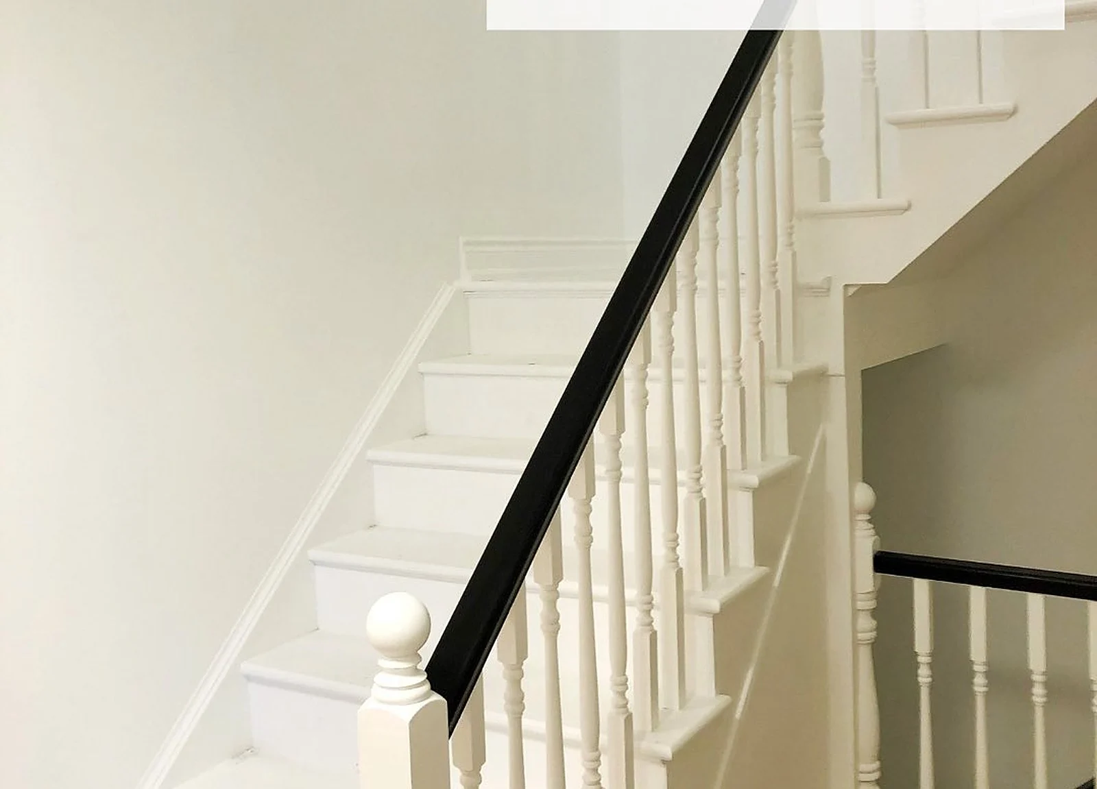 AFTER: staircase painted white with black handrail