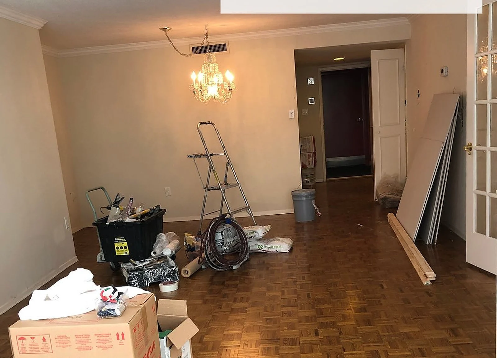 BEFORE: living room cluttered with renovation materials