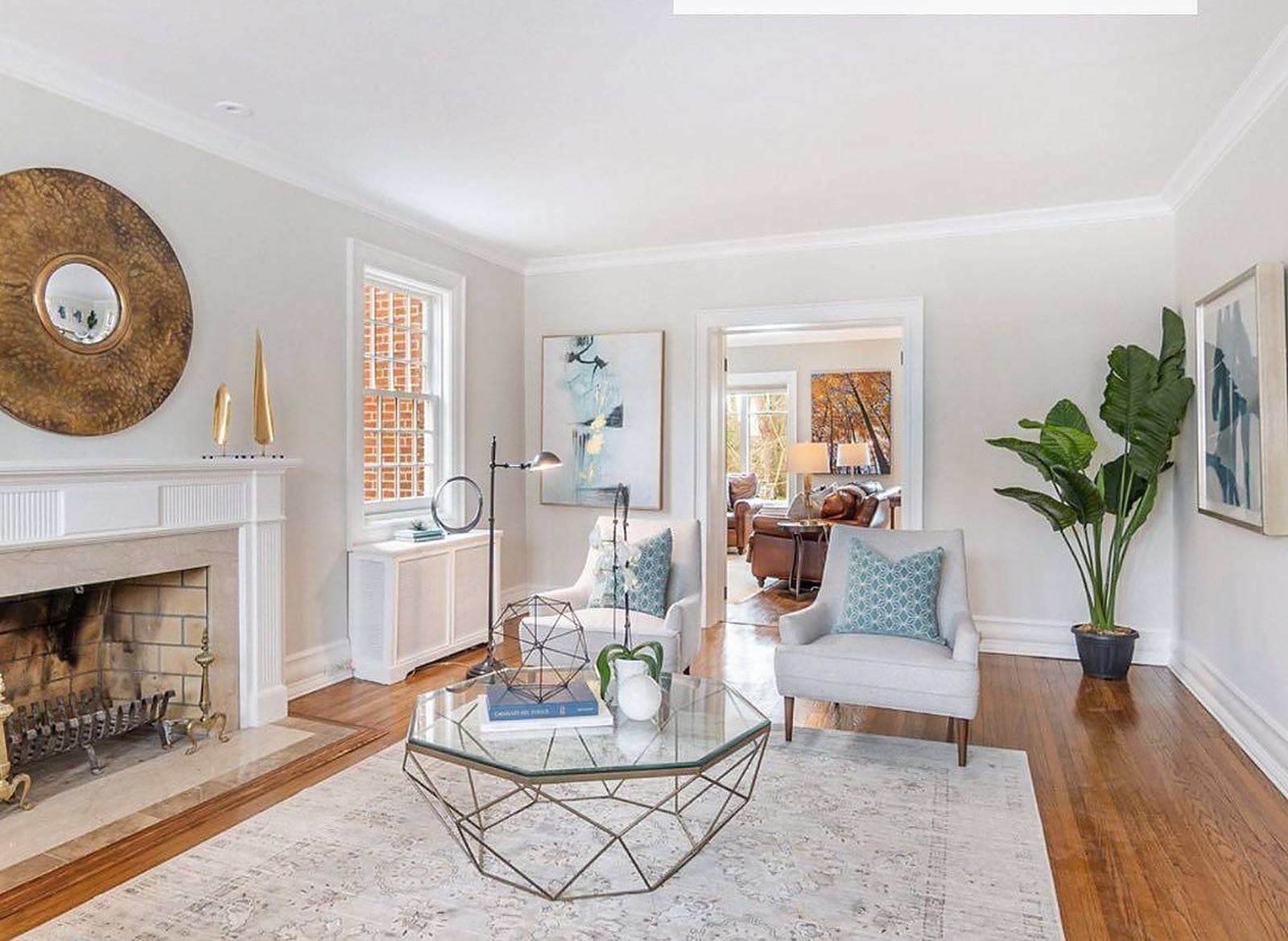 Bright living room with a white fireplace after an interior repaint in Lawrence Park