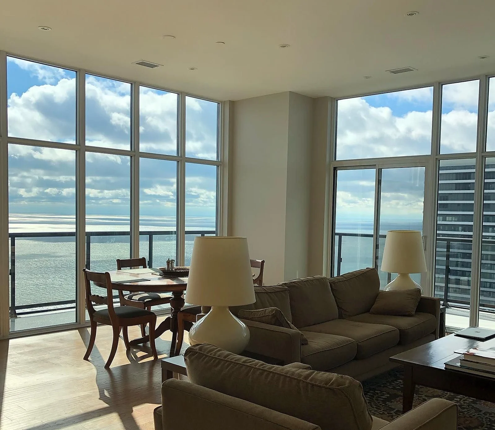 Penthouse living room with floor-to-ceiling lake views