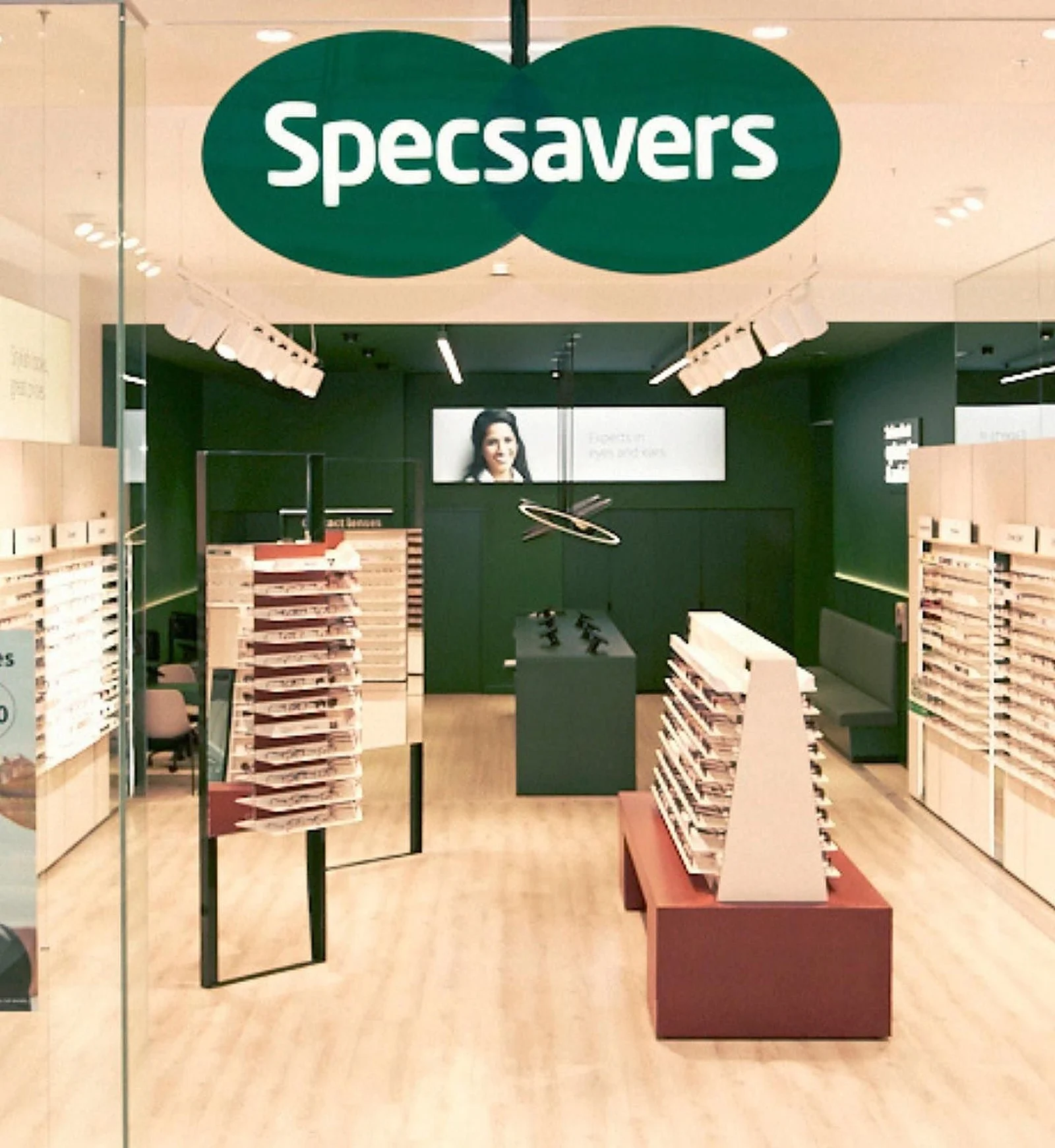 Specsavers store with green feature walls
