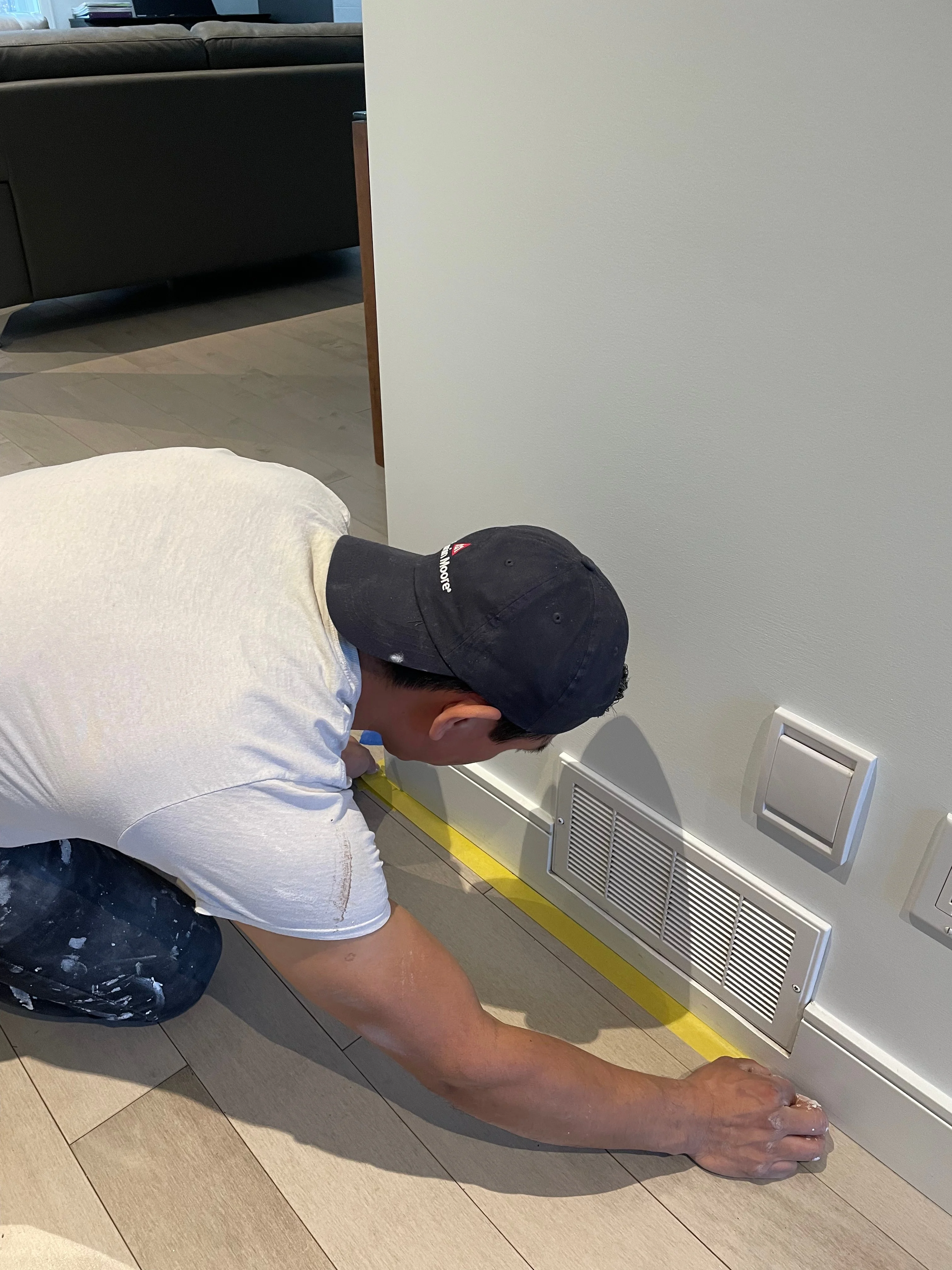 Taping a clean line along a baseboard
