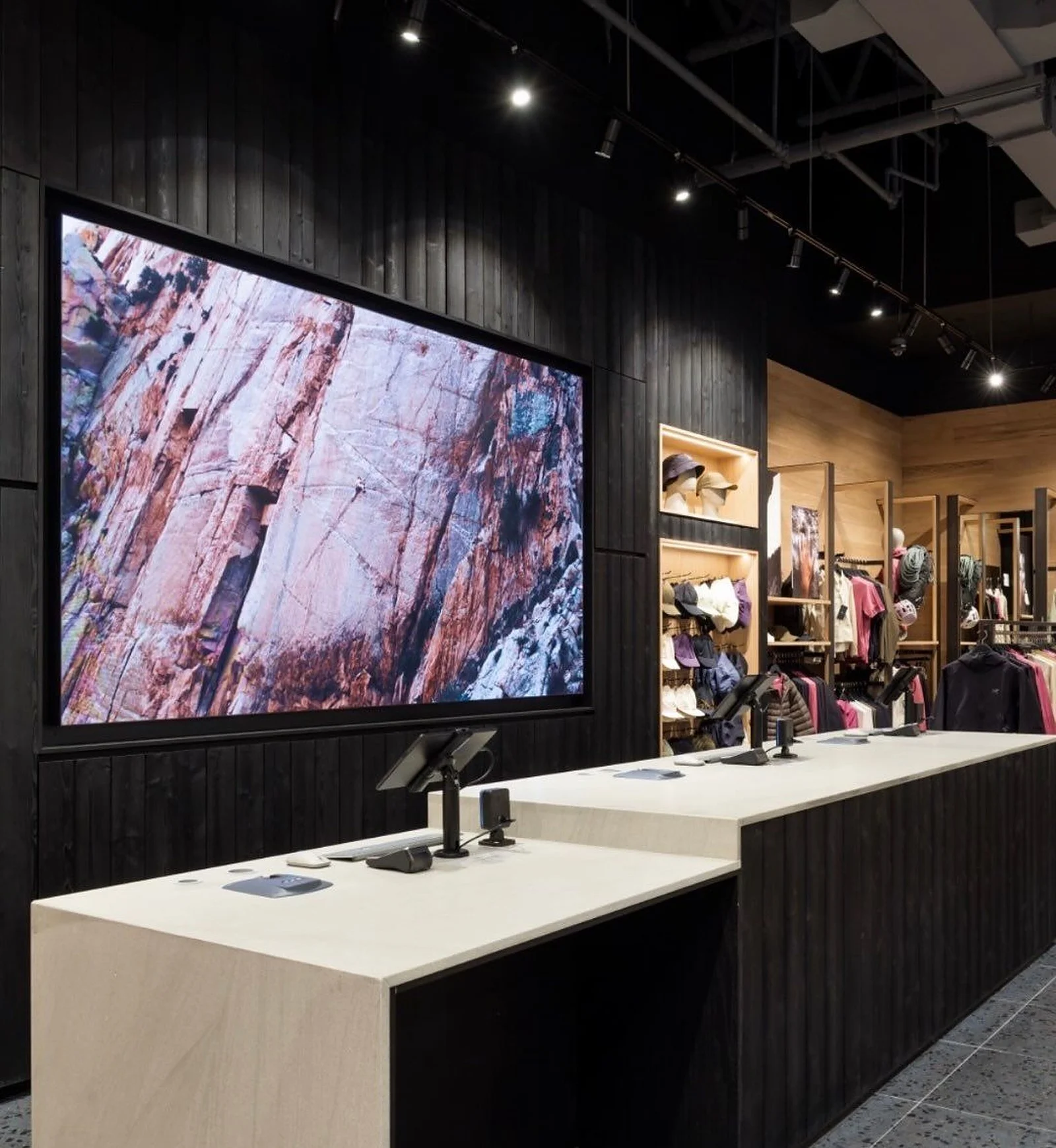 Black ribbed walls and display counter at Arc’teryx